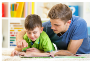 man reading book to young boy