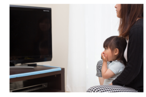 Mom and daughter watching TV together