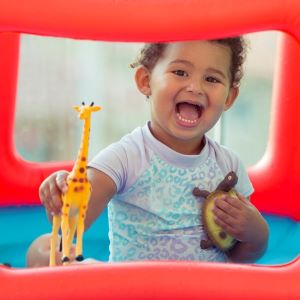 Child playing with toy animals